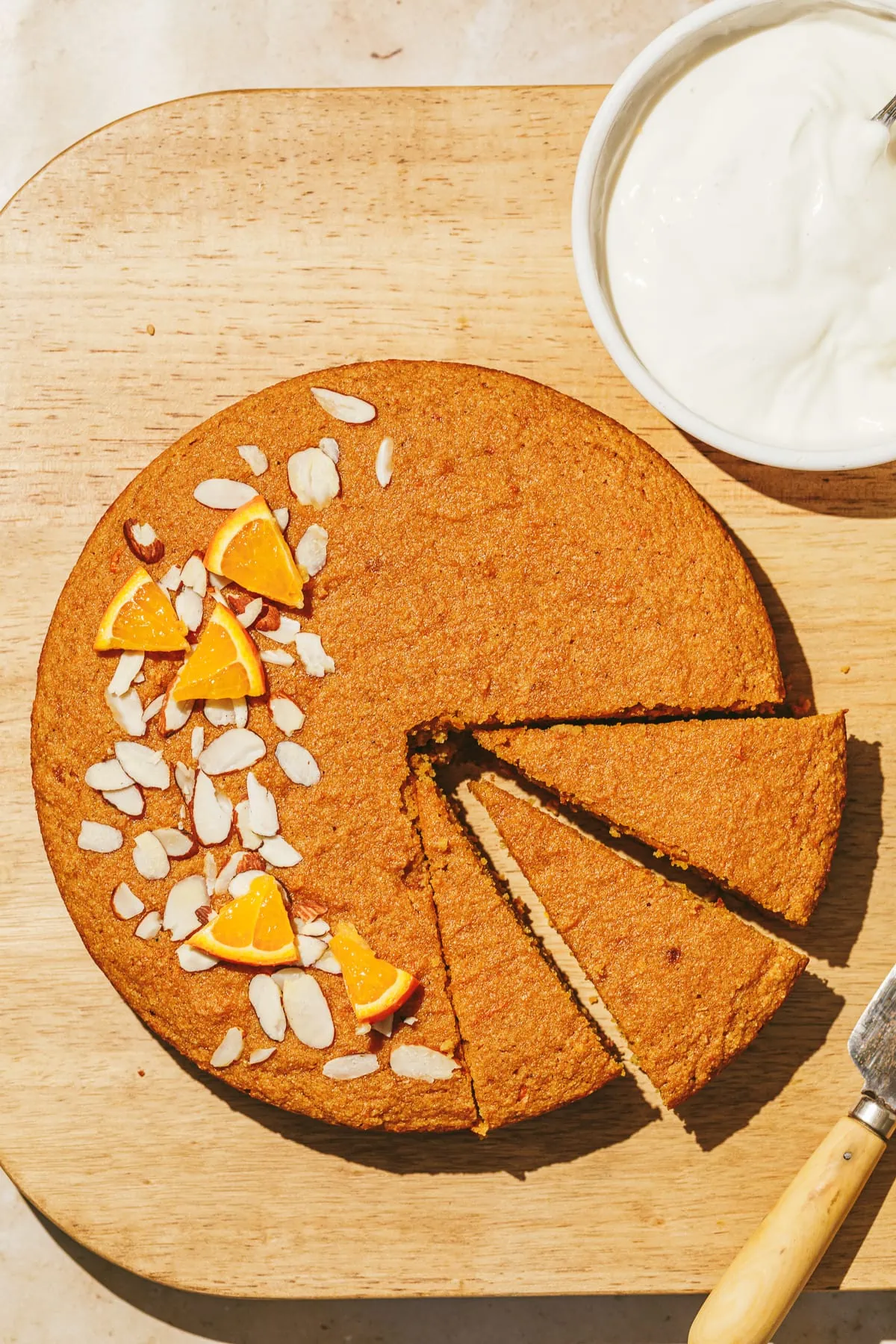 Overhead image of gluten-free orange cake with almond slices on top.