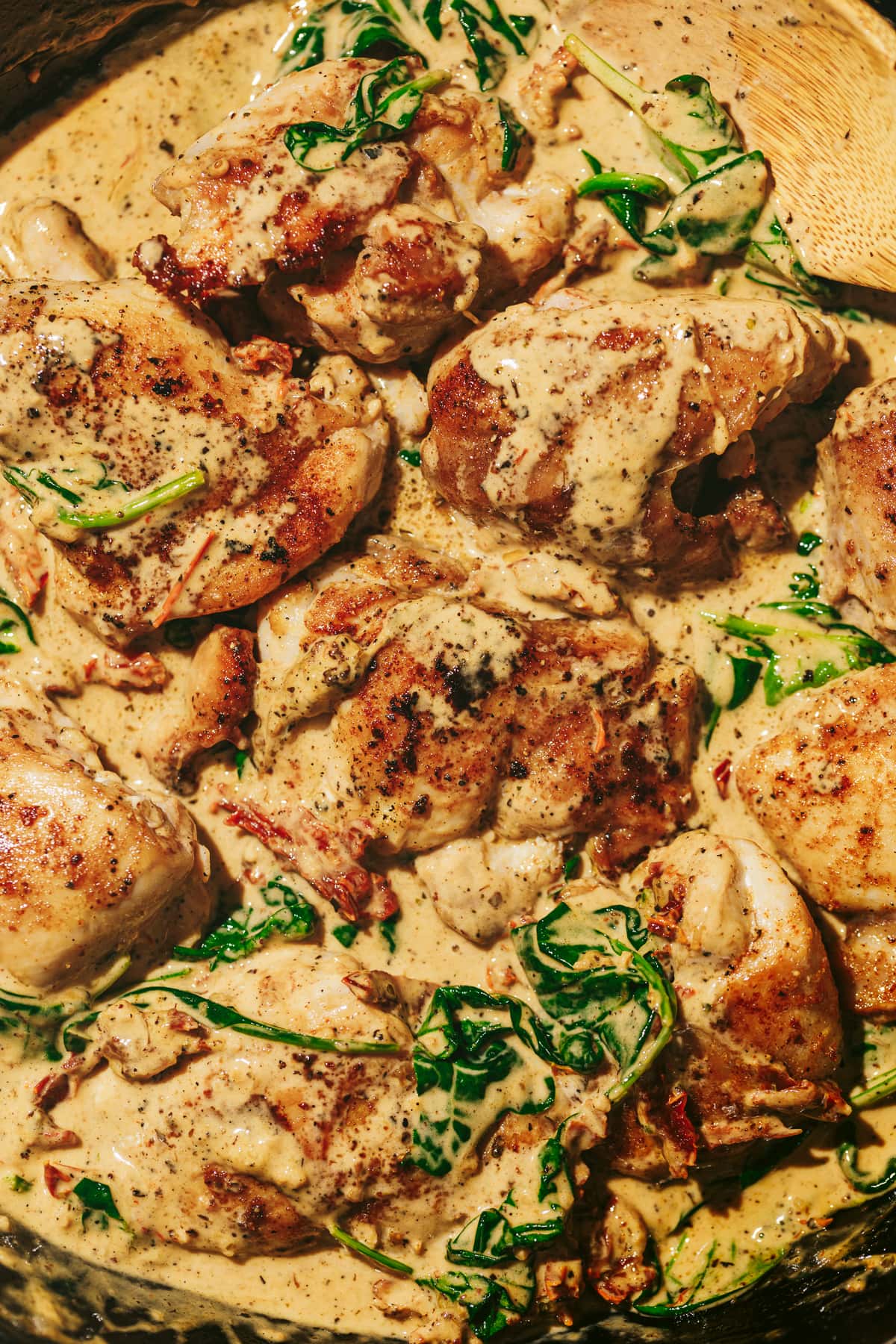 Closeup of keto tuscan chicken in a pan with cream sauce.
