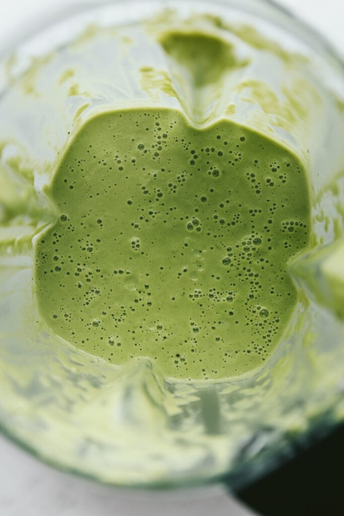 Closeup of broccoli almond soup in a blender.