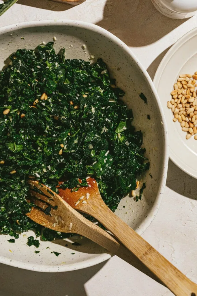 Tossed kale with pine nuts for Tuscan kale salad.
