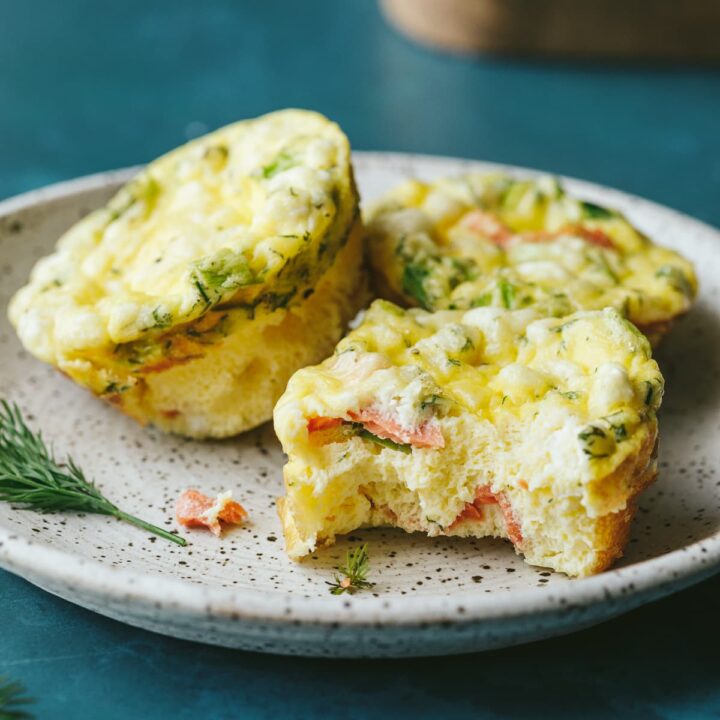 Keto egg bites on a white plate with garnishes.
