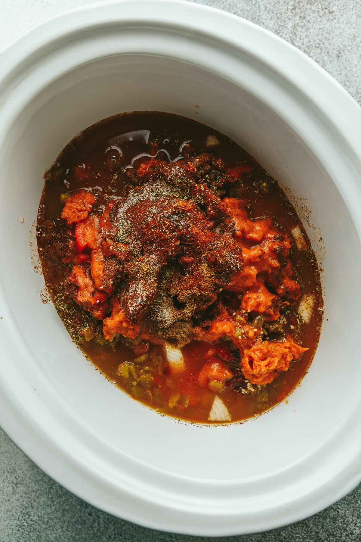 Ingredients for pumpkin chicken chili in a crockpot.