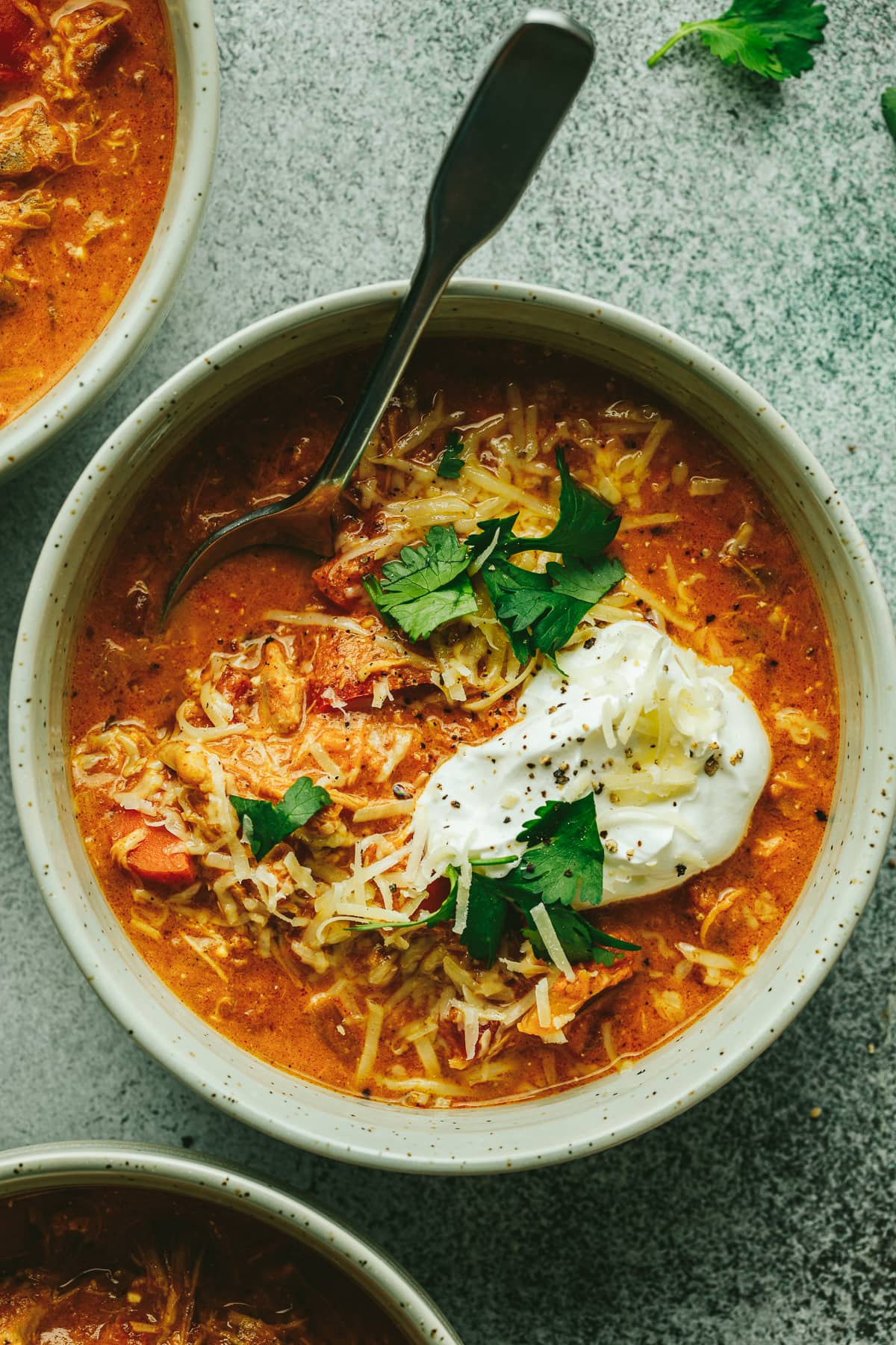 Closeup of a bowl of keto pumpkin chicken chili with toppings.