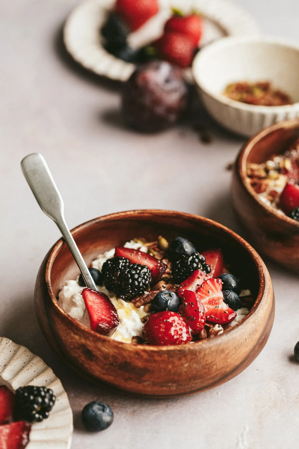A wooden bowl with a serving of cottage cheese with fruit.