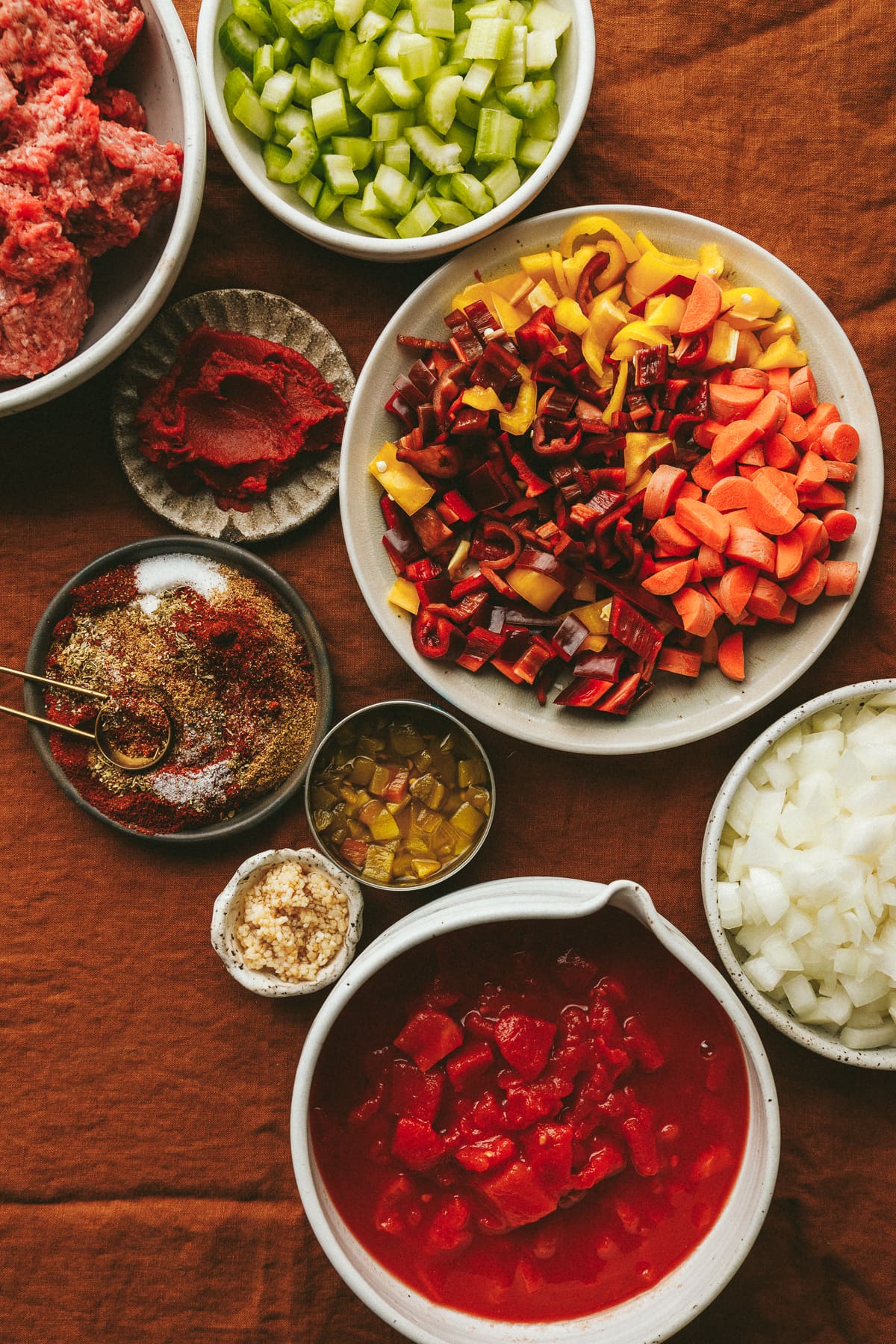 Ingredients for crockpot no bean chili on an orange tablecloth.