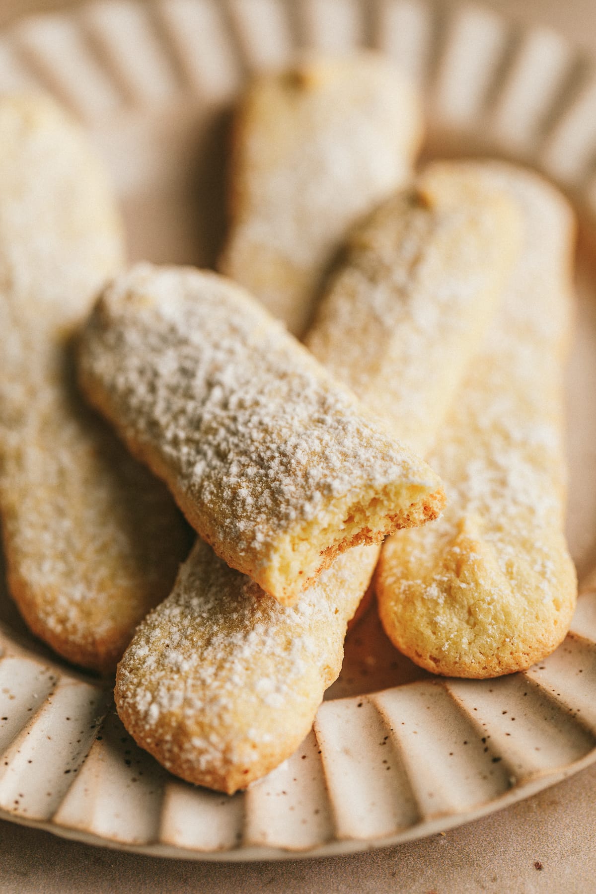 Sugar free ladyfingers on a scalloped plate.