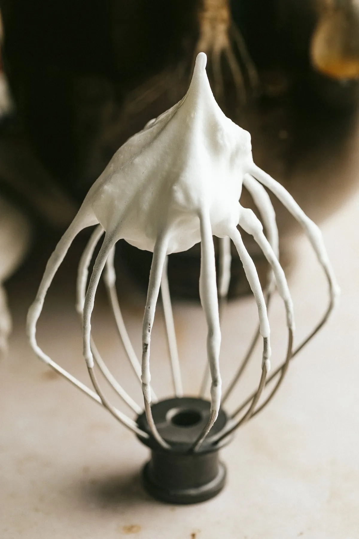 Whipped egg whites on a wire whisk attachment.