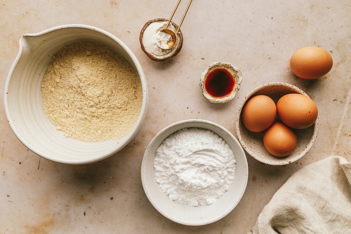 Ingredients on a marble surface for sugar free ladyfingers.