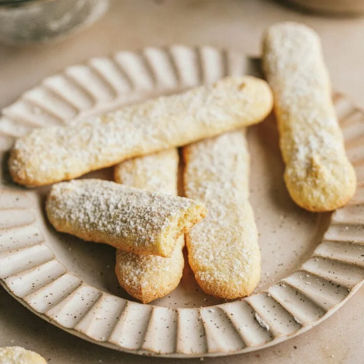 Keto ladyfingers on a plate with dusting of powdered sweetener.