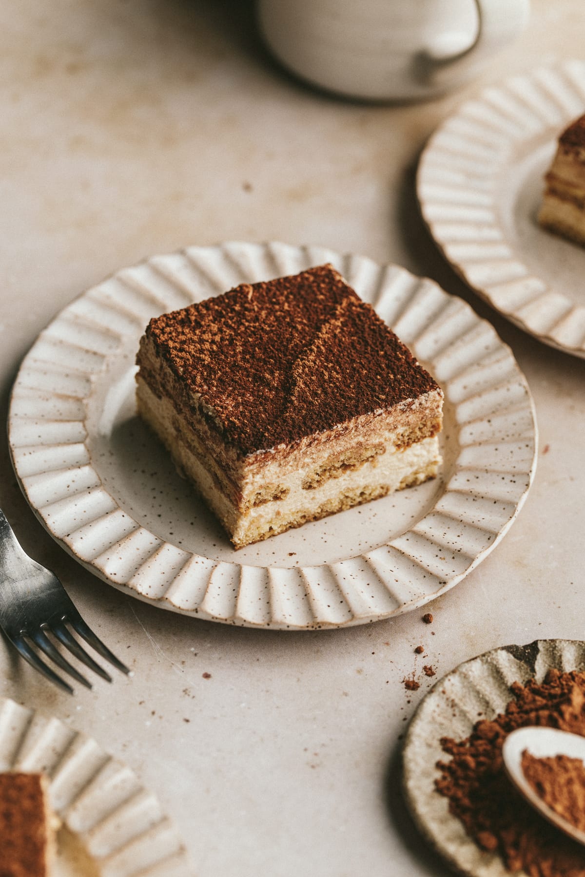 Plates of keto tiramisu slices and a fork.