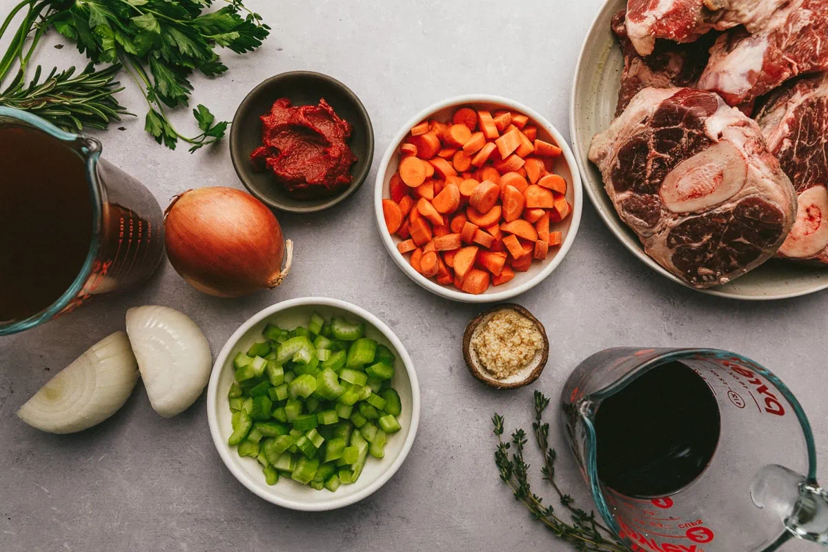 Ingredients for braised beef shanks arranged on a marble surface.