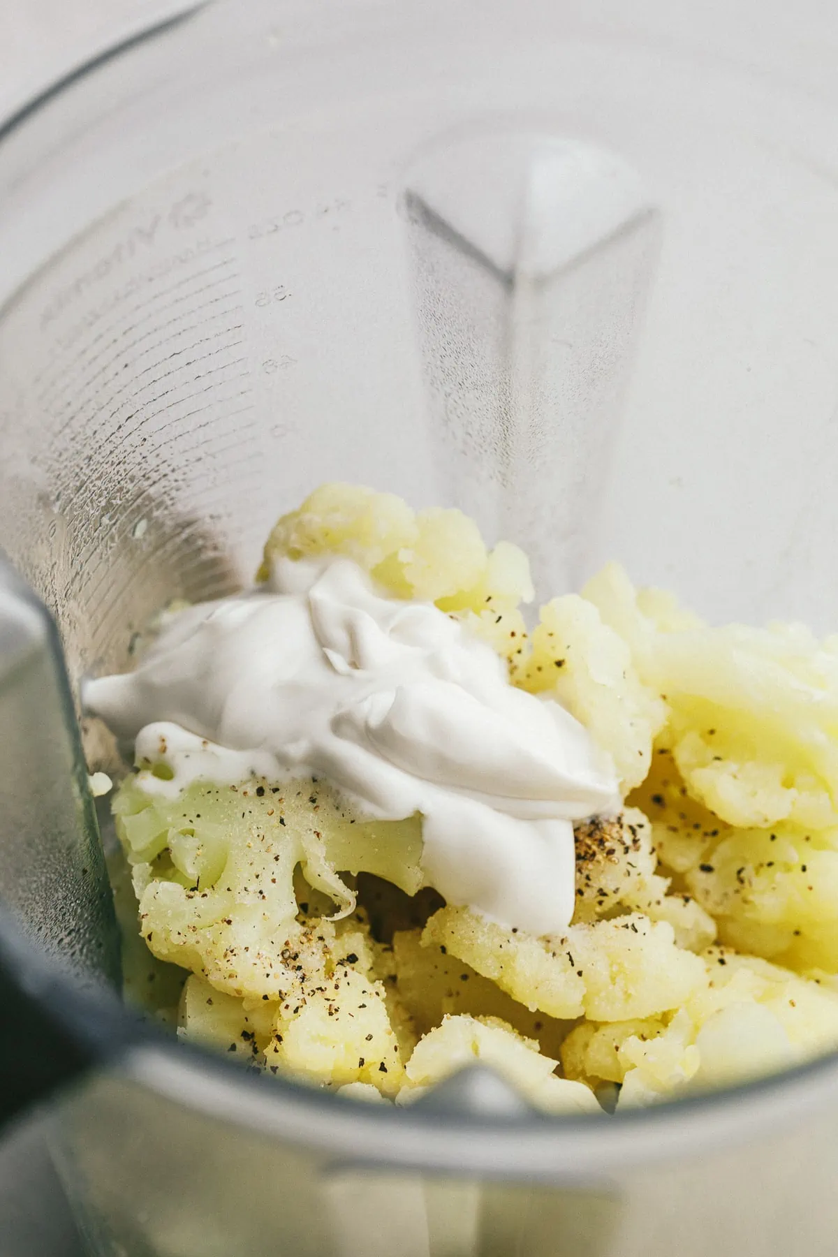 Ingredients for dairy free mashed cauliflower in a blender. 