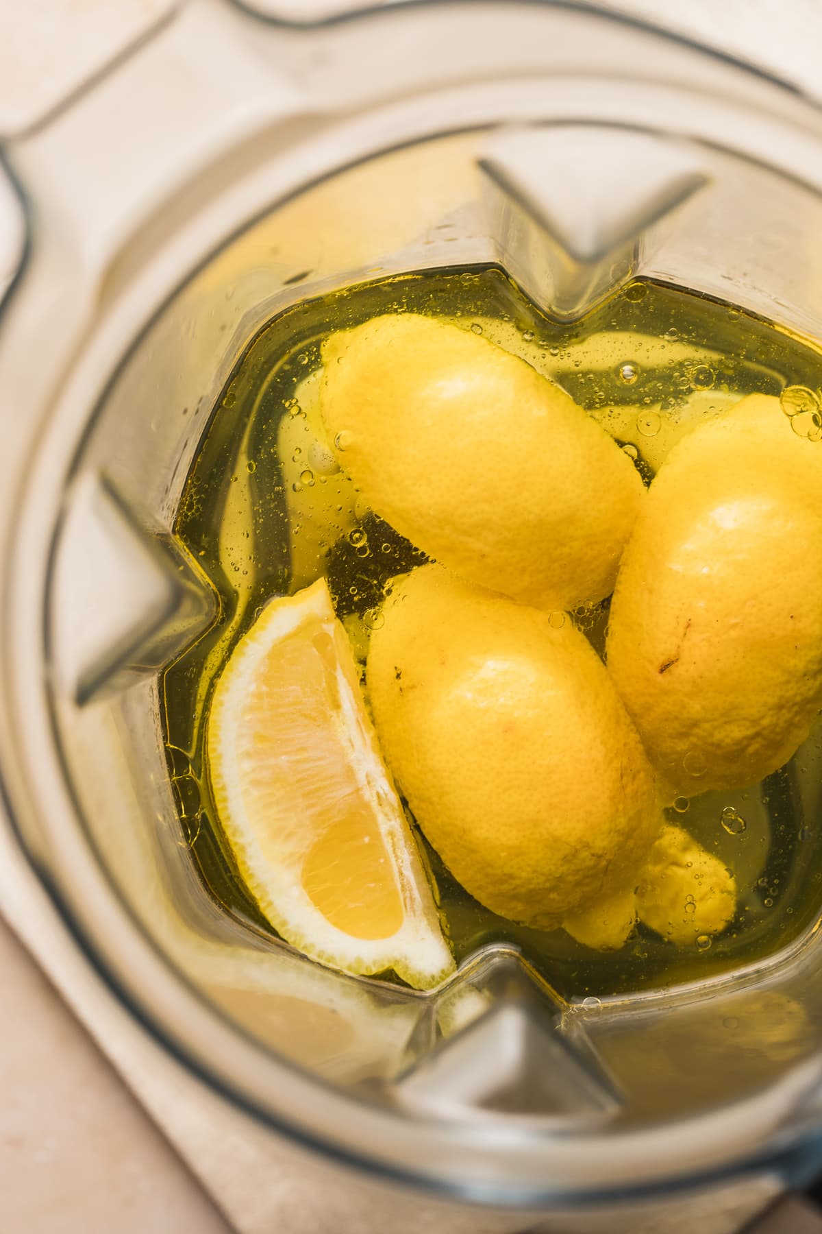 Ingredients for TikTok olive oil and lemon juice drink in a blender.