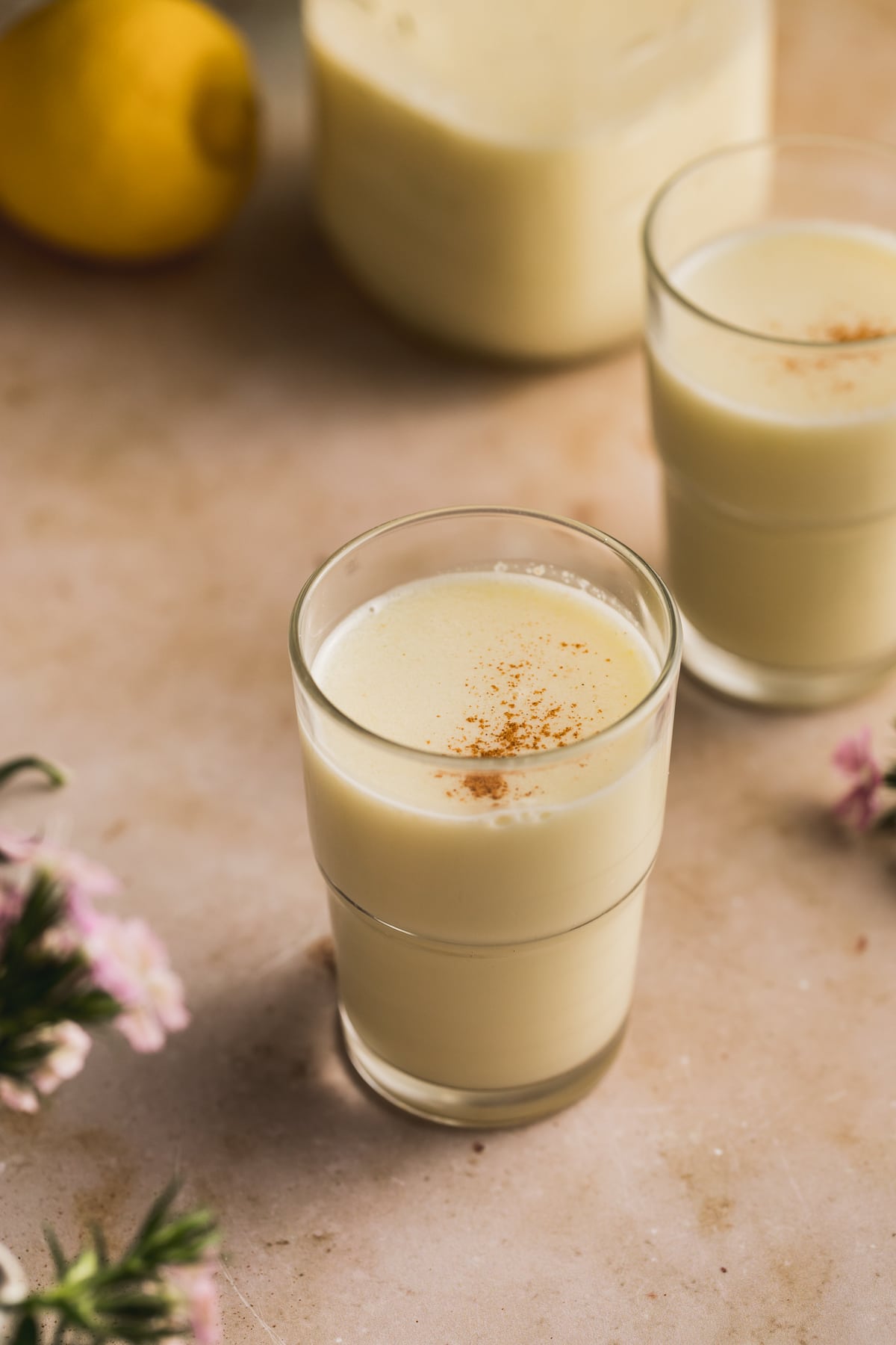 A small glass full of creamy olive oil and lemon juice.