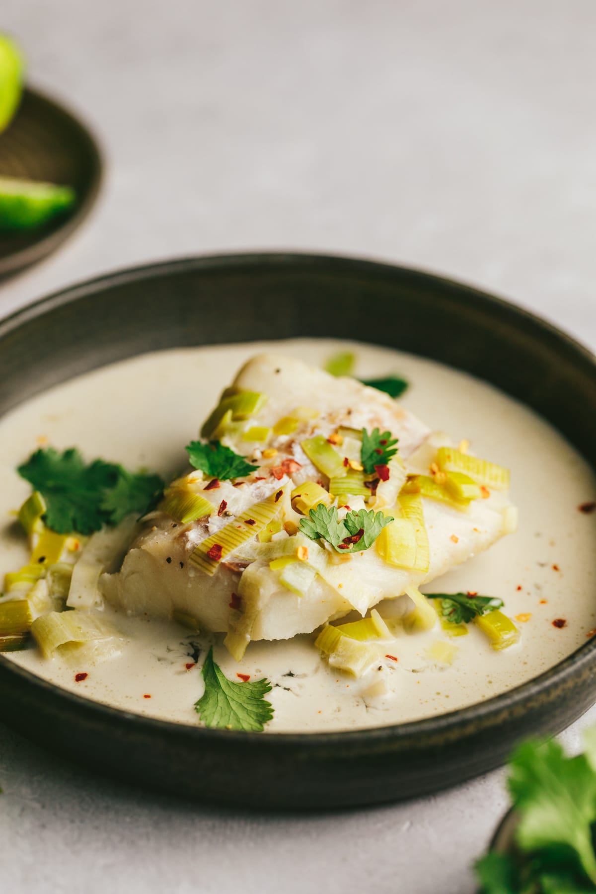 A piece of cod in a coconut milk broth.