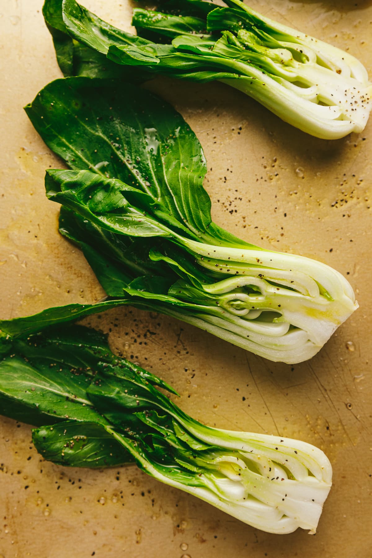 Bok choy on a sheet pan ready for roasting.