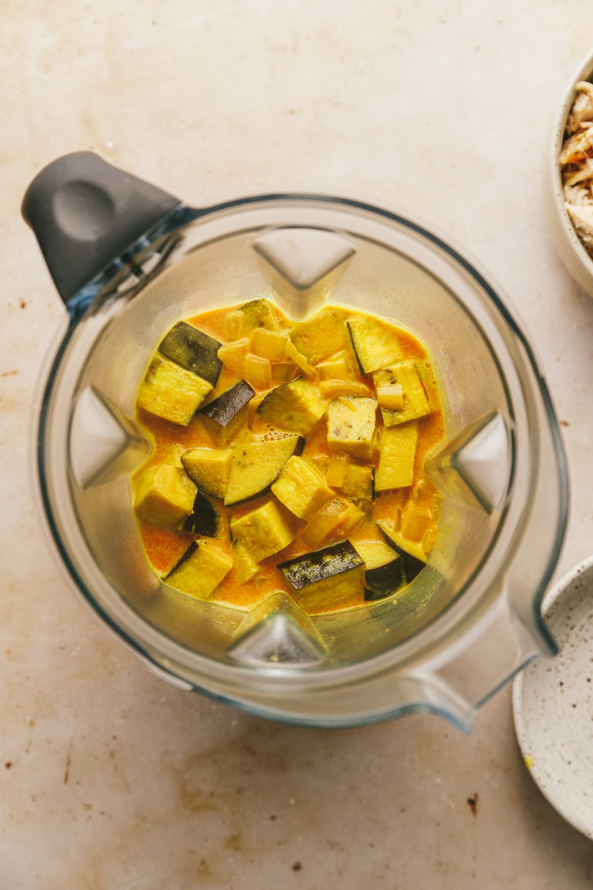 Eggplant and curry sauce in a blender.