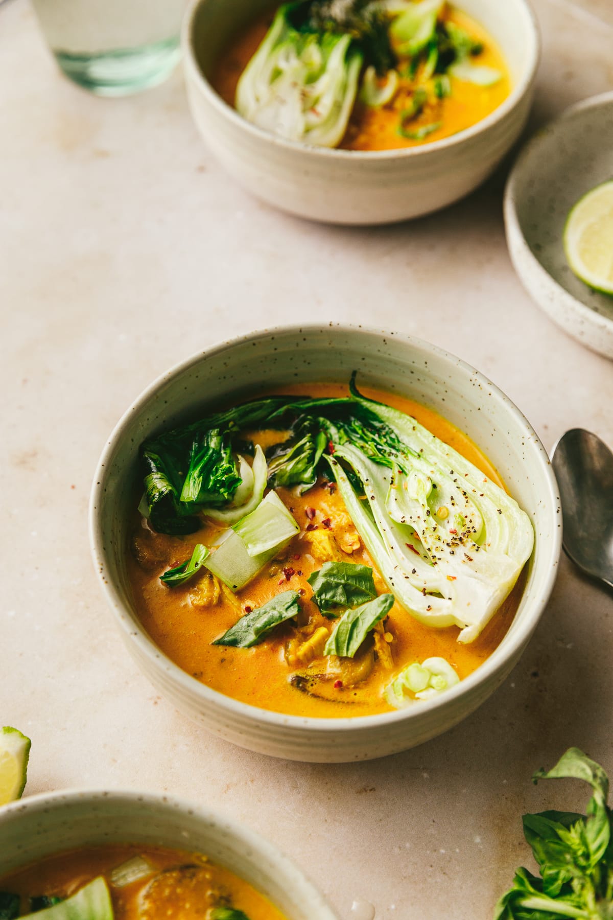 A bowl of keto chicken curry soup with roasted bok choy on top.
