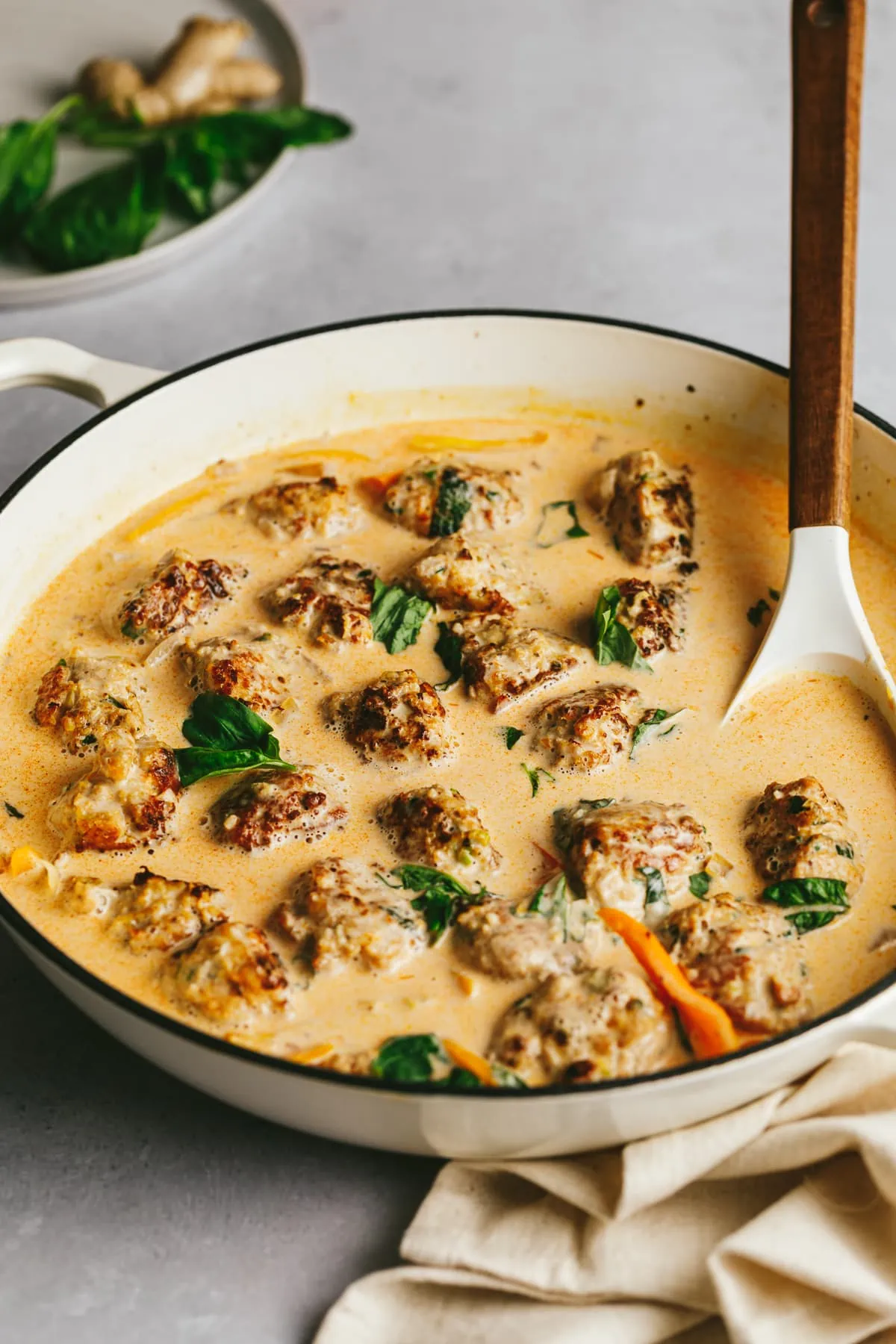 A braiser pan with low-carb turkey meatballs and curry sauce.