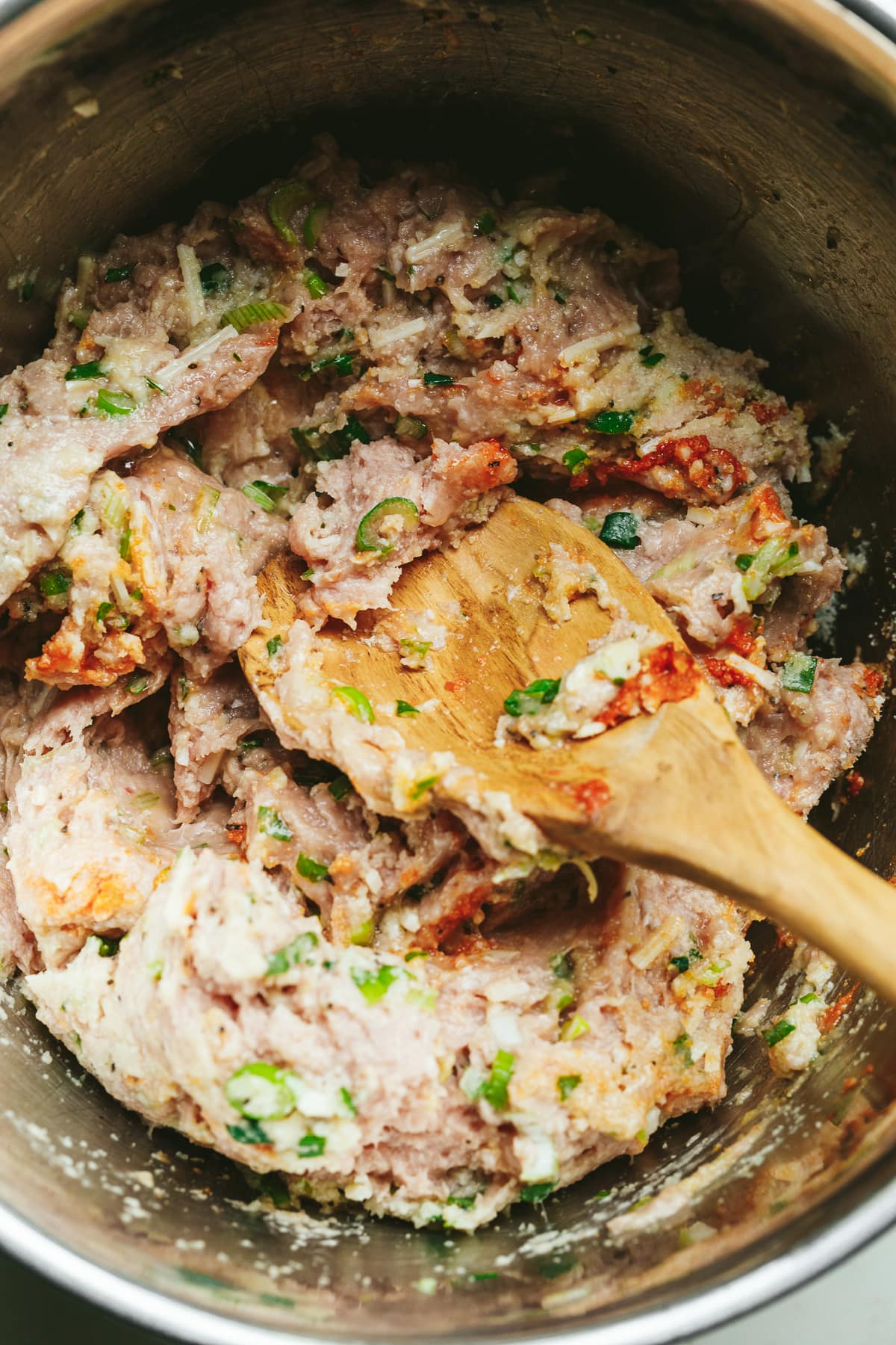Ground turkey in a large mixing bowl for keto turkey meatballs.