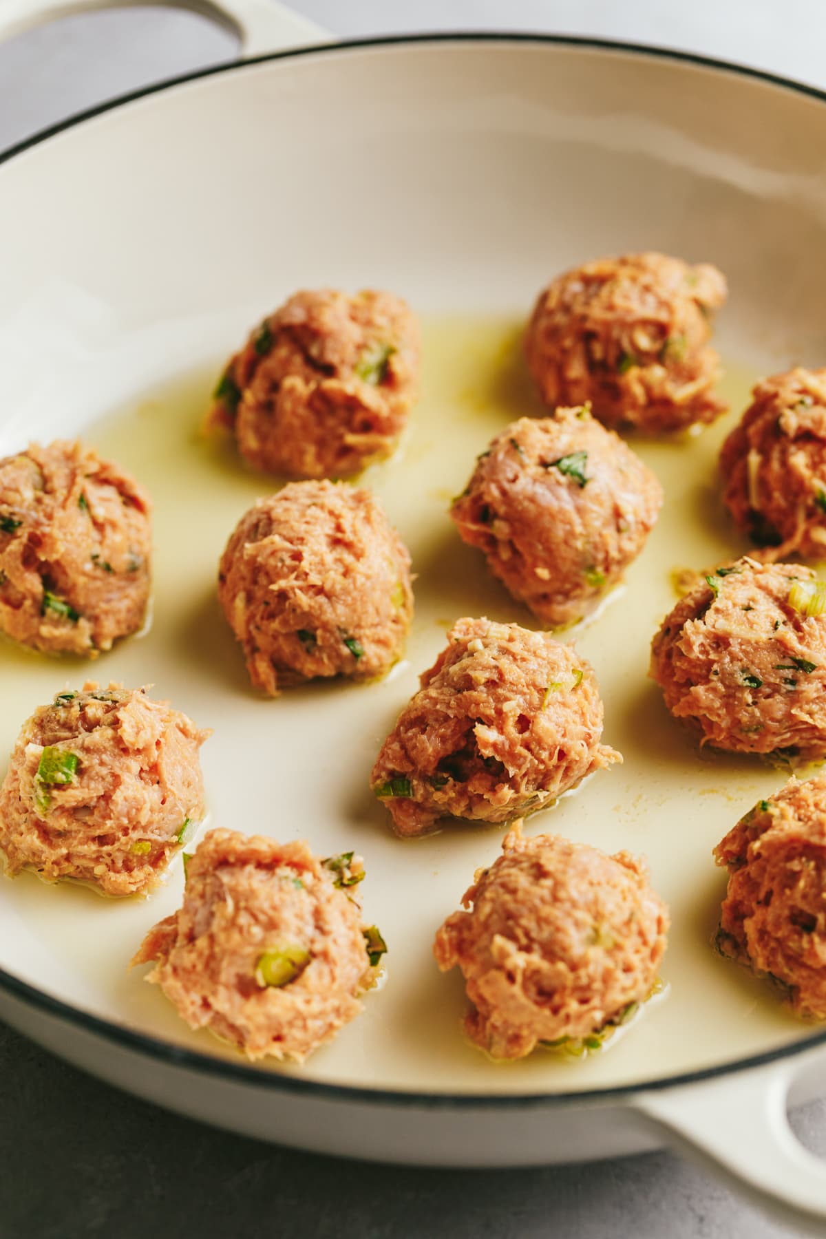 Ground turkey in a skillet for turkey meatballs.