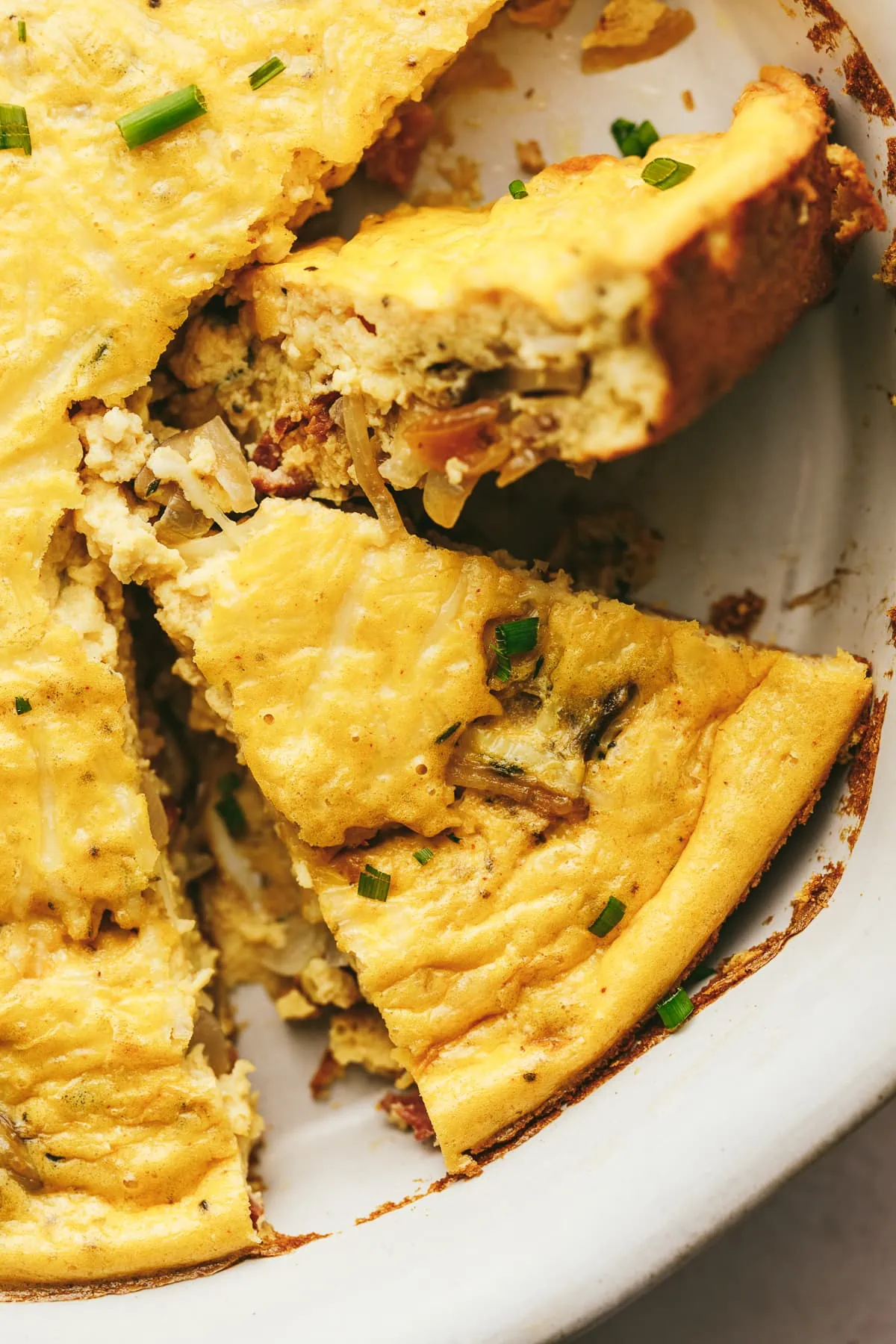 A slice of low-carb cottage cheese quiche with mushrooms and onions.