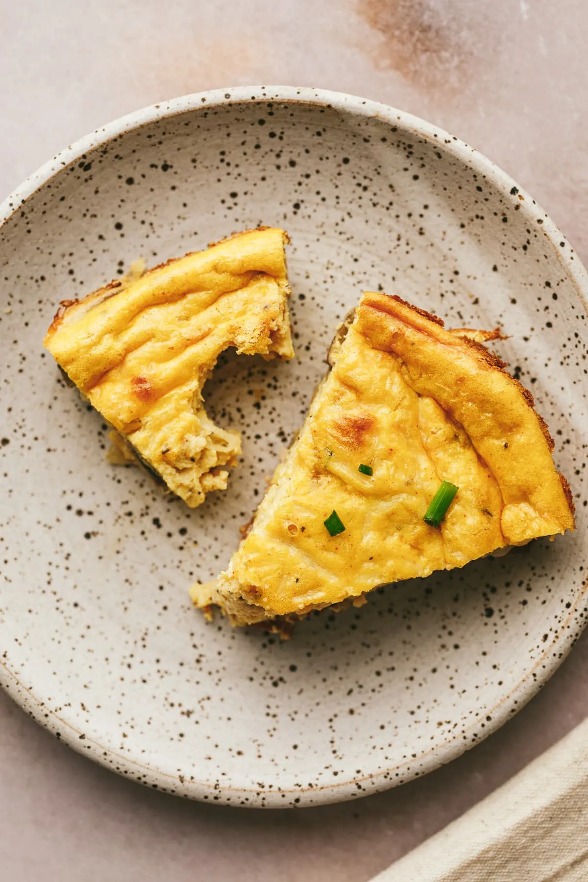 Cottage cheese quiche slices on a speckled plate.