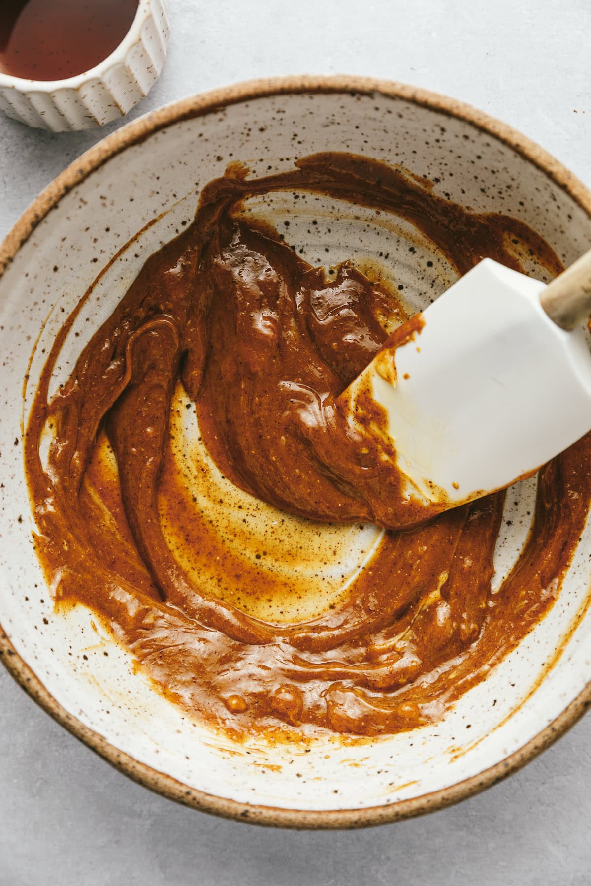 Mixing the wet ingredients for cookie dough protein balls.
