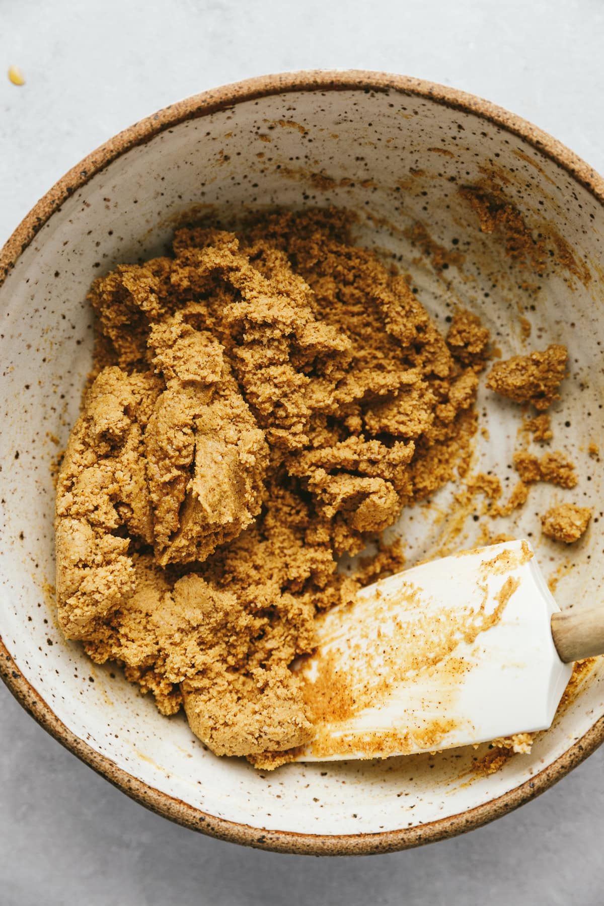 Mixing the cookie dough ingredients with a spatula.