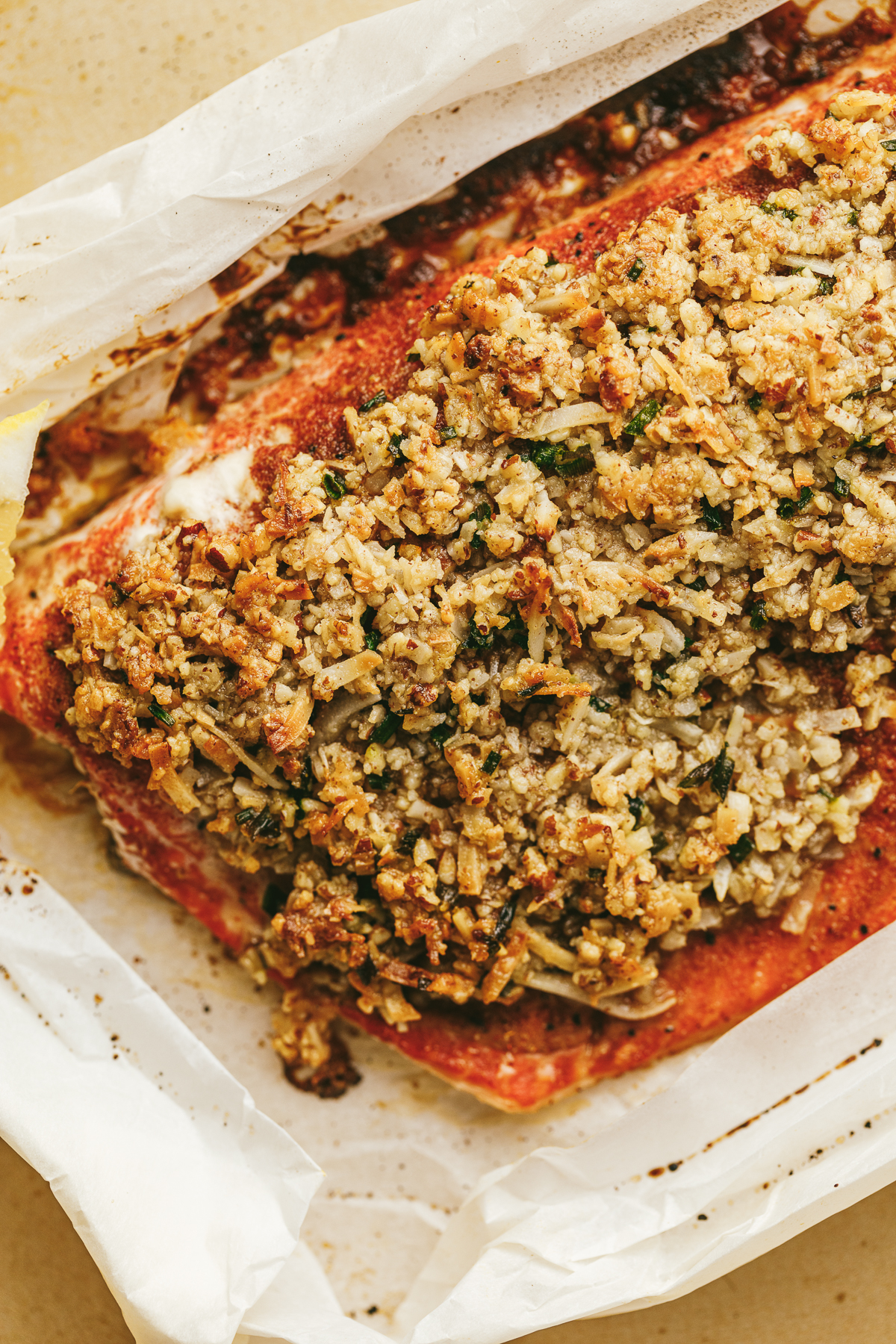 Pecan coconut crust on top of baked salmon.