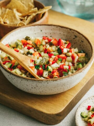 A large bowl of pickle de gallo with tortilla chips behind it.