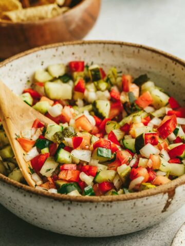 Pickle de gallo in a bowl with a wooden spoon.