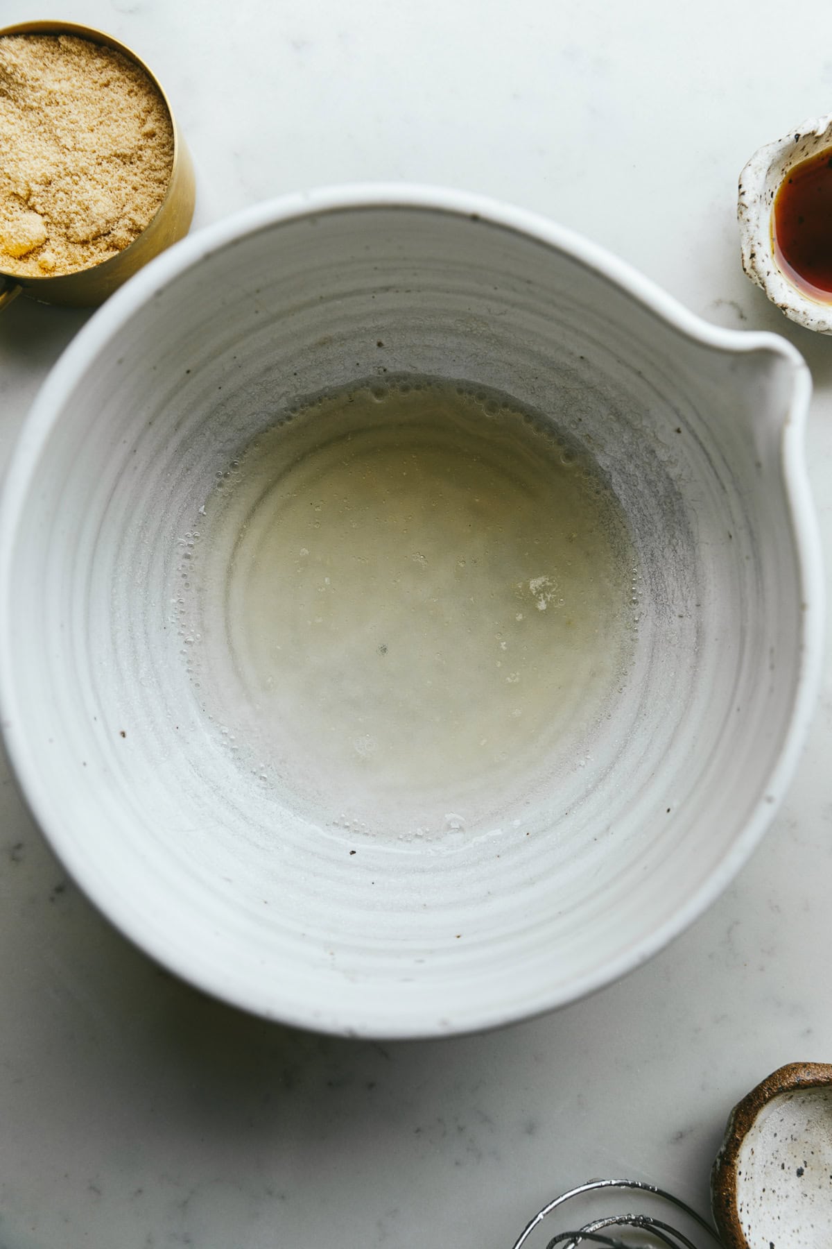 Gelatin and water blooming in a white bowl.