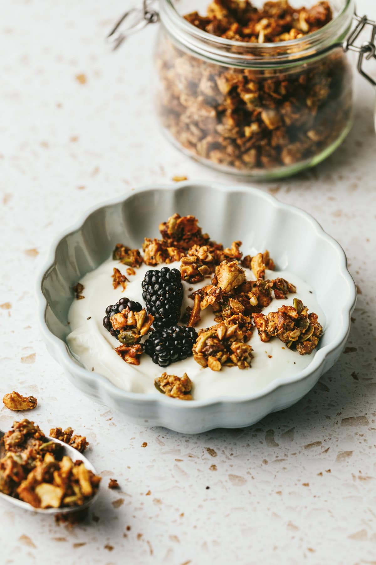 A bowl of vanilla yogurt with grain-free granola sprinkled on top.