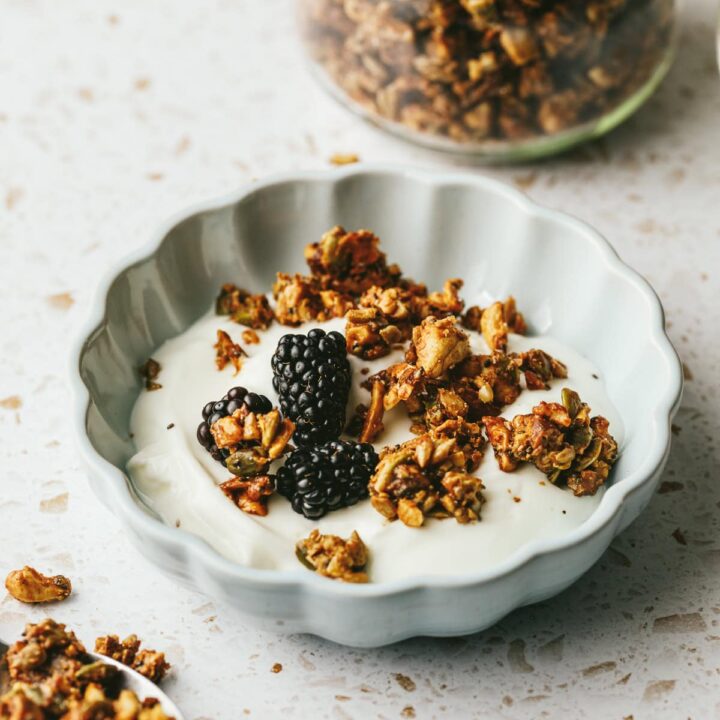 Vanilla almond butter granola on top of yogurt with blackberries.