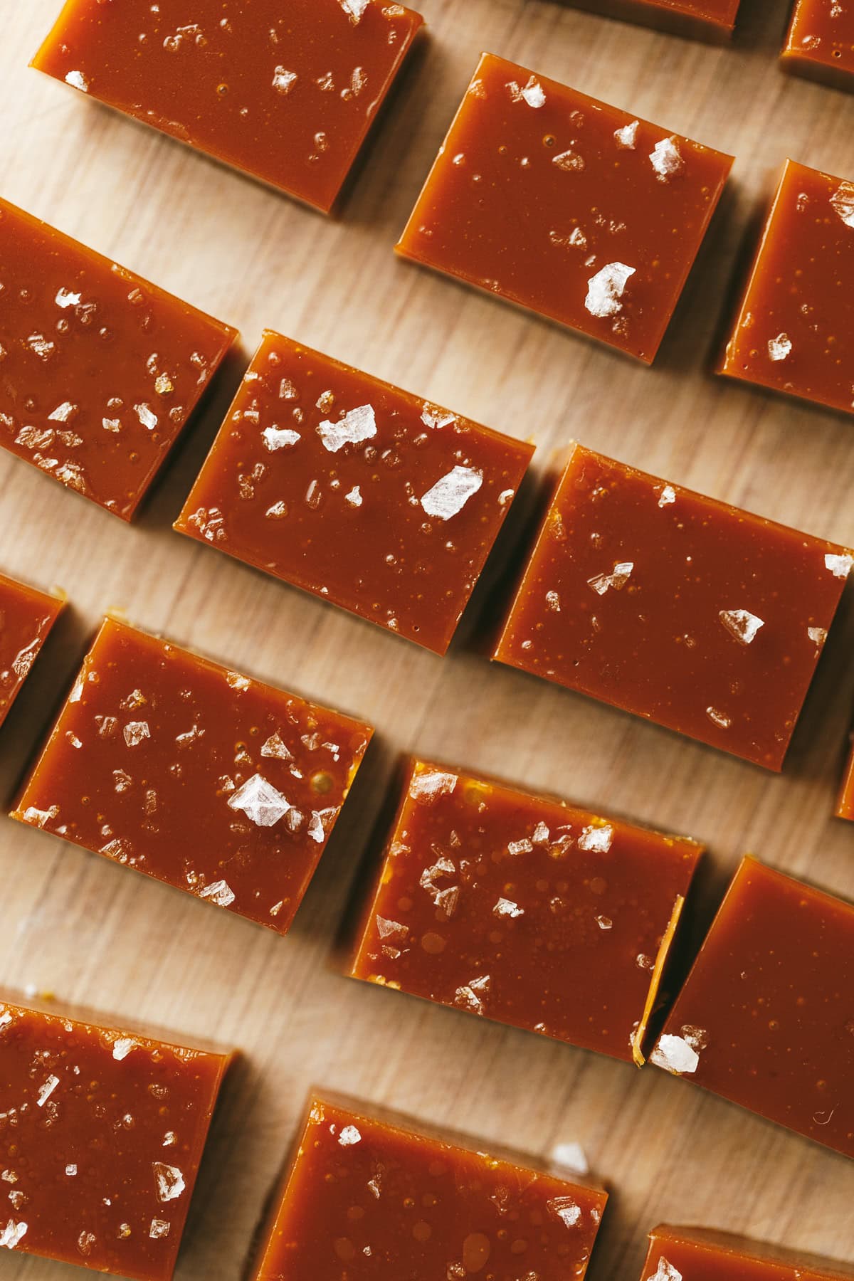 Squares of sliced keto caramels with flaky sea salt.