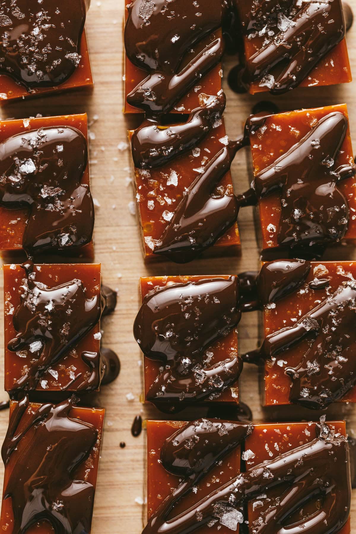 Chocolate drizzled onto keto caramels.