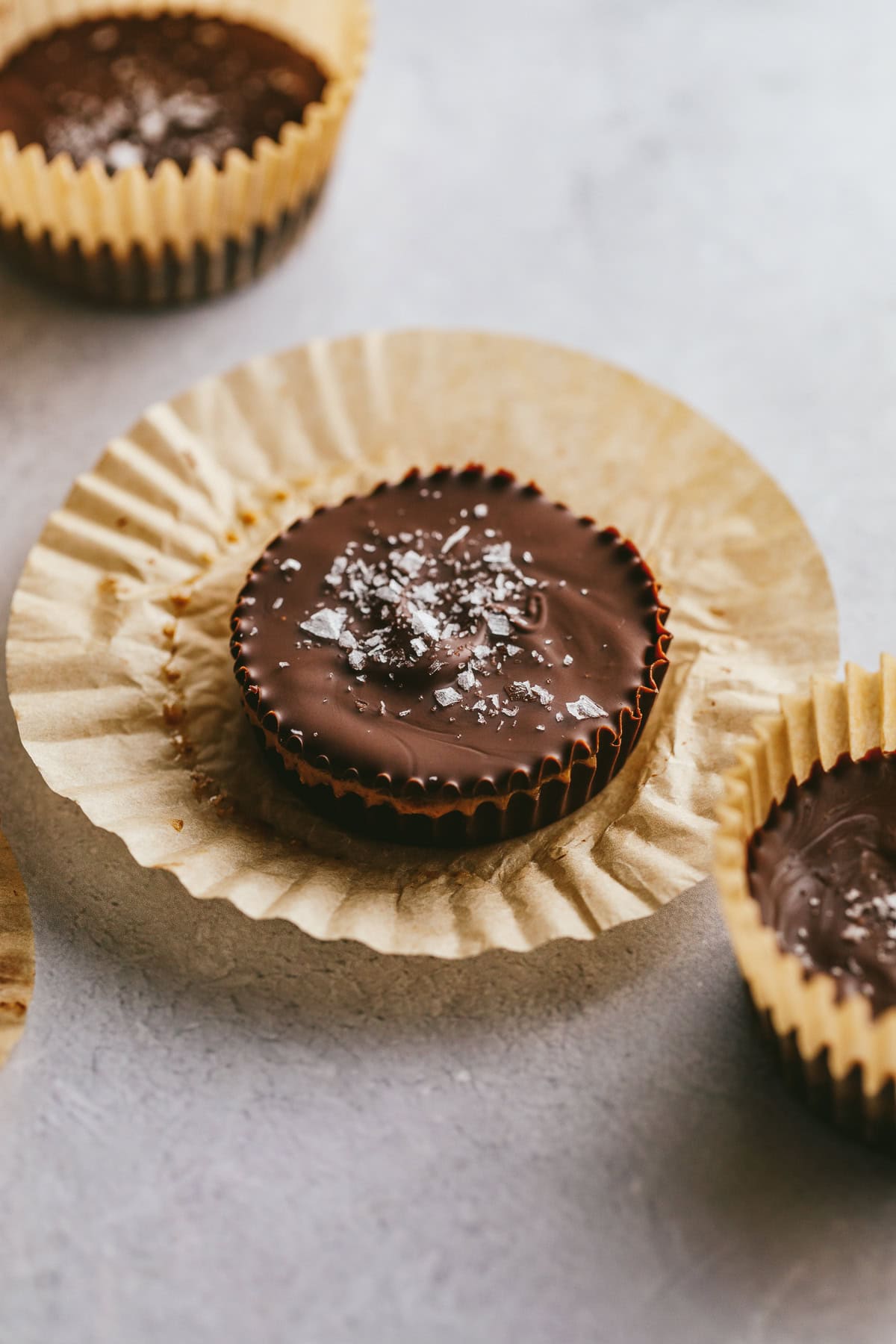 An unwrapped dark chocolate almond butter cup.