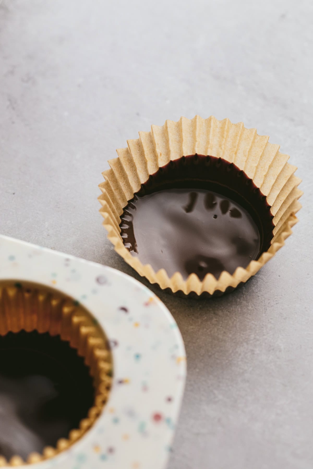 Dark chocolate in a parchment paper muffin cup.