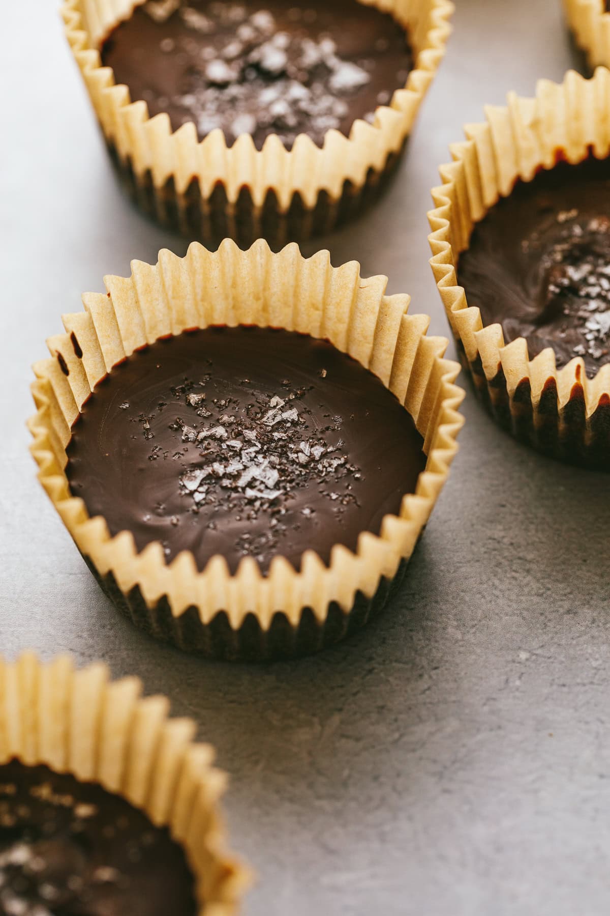 Dark chocolate almond butter cups with sea salt on top.