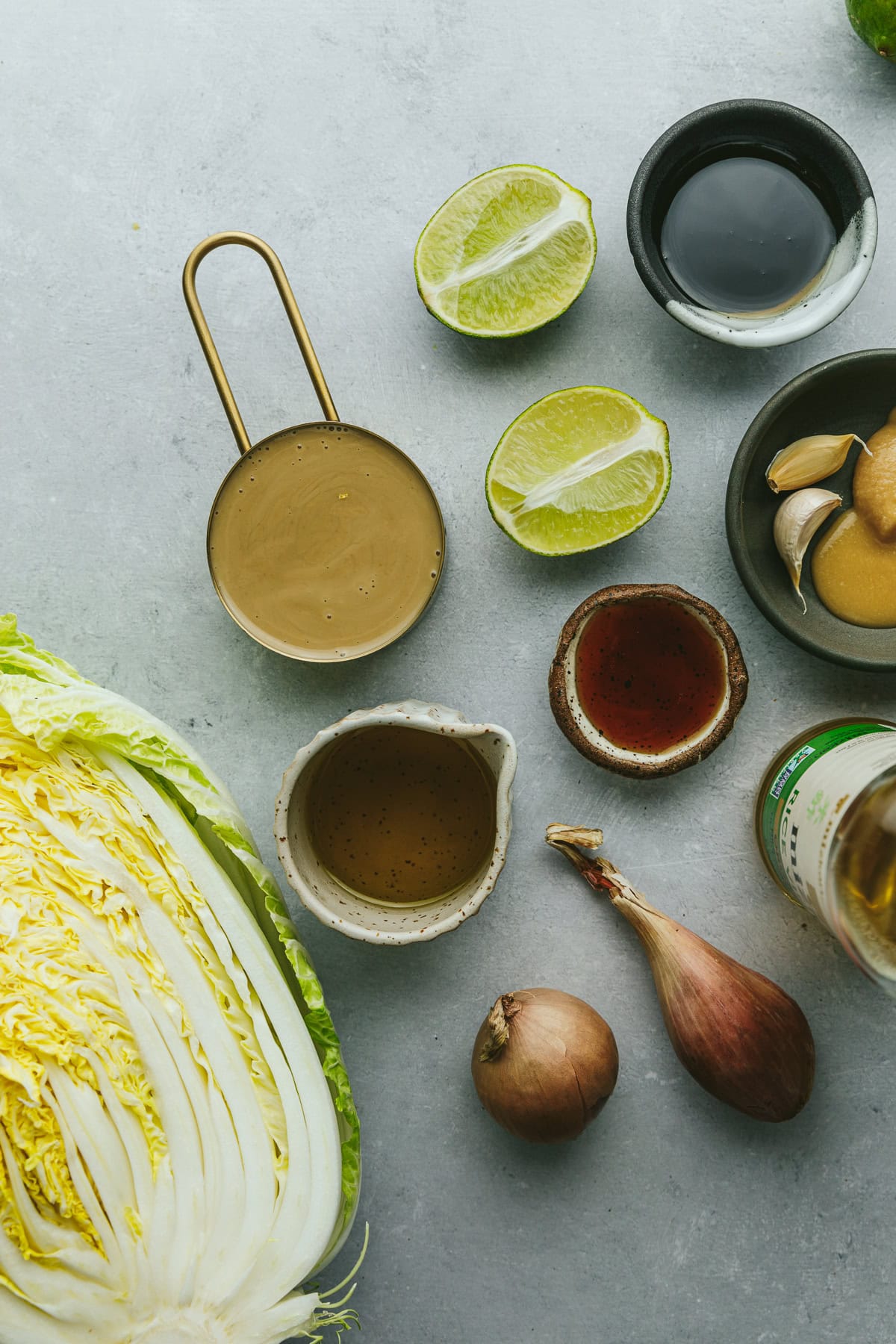 Ingredients for roasted cabbage recipe on a light gray surface.