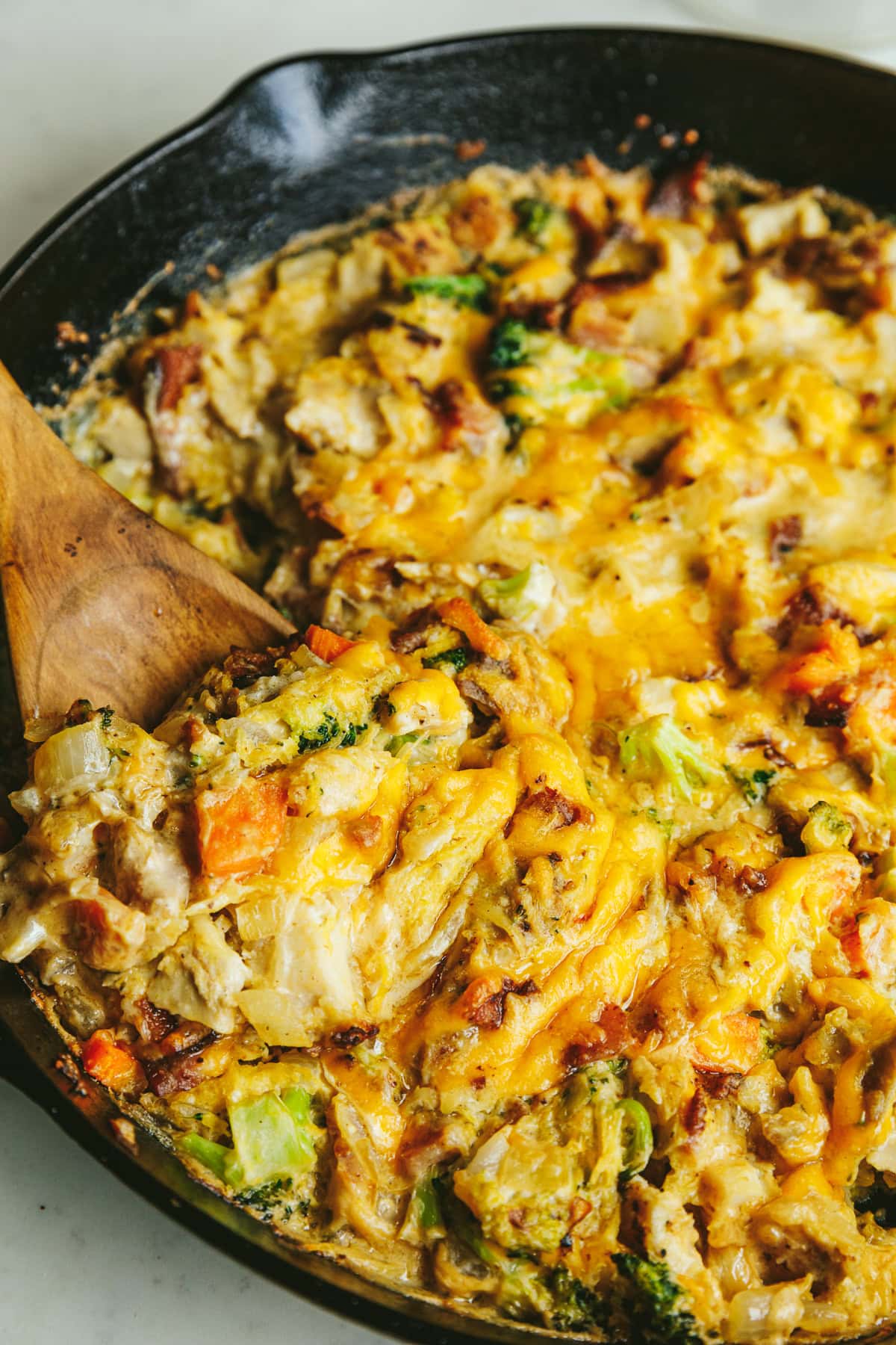 Scooping out a serving of Alfredo chicken and broccoli bake.