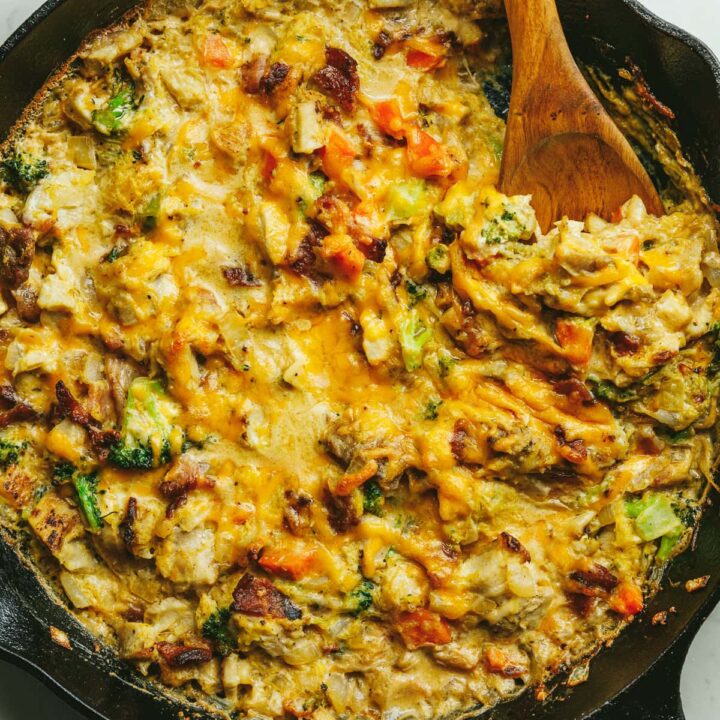 Alfredo chicken and broccoli bake in a black cast iron skillet.