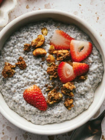 Basil seed pudding with strawberries and grain-free granola in a bowl.