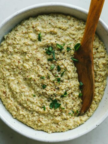 Low-carb polenta in a serving bowl with parsley.