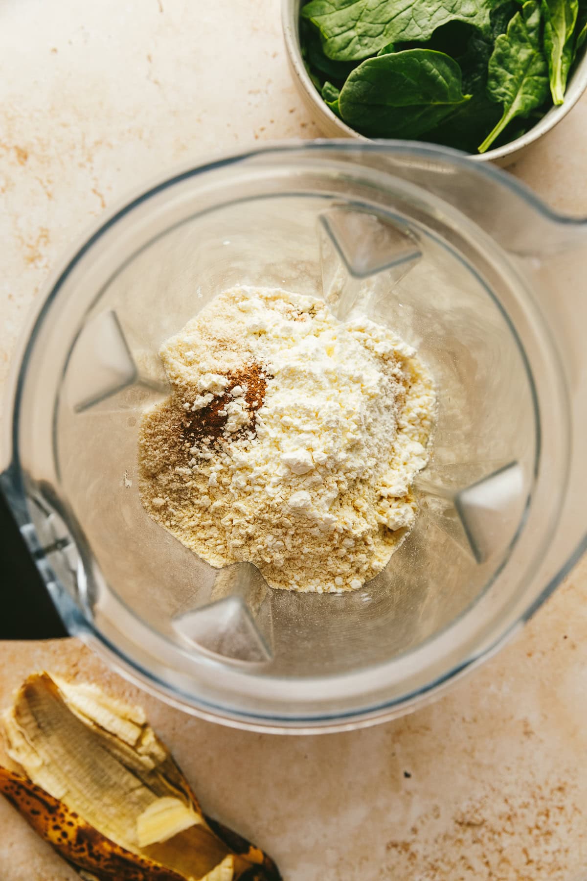 Adding dry ingredients to a blender.