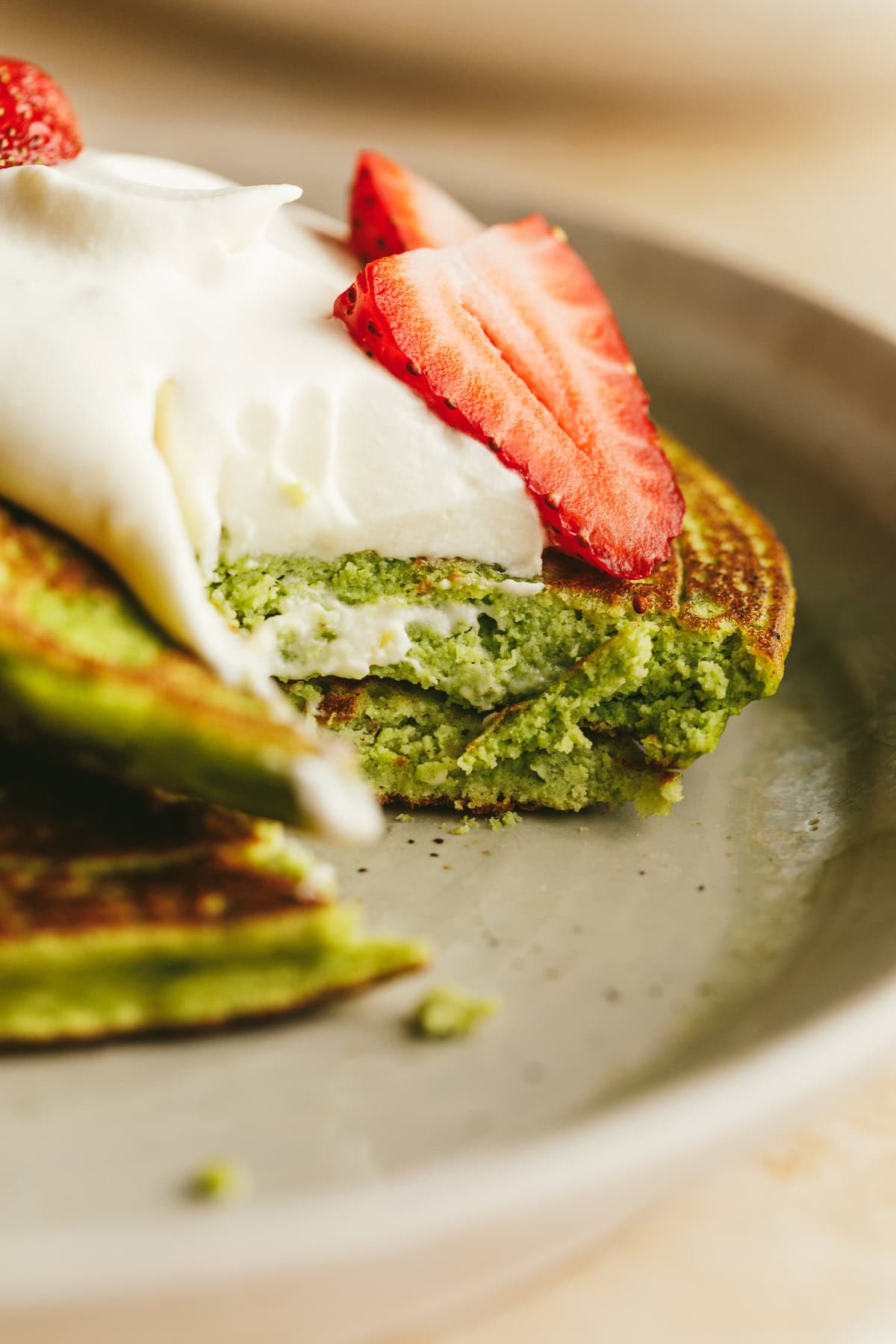 Closeup of a bite taken out of two pancakes.