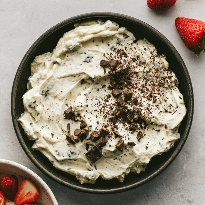 Mascarpone dip in a serving dish with strawberries.