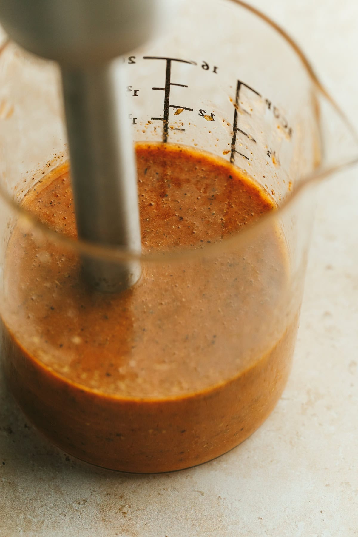 Immersion blender making the pizza salad dressing.