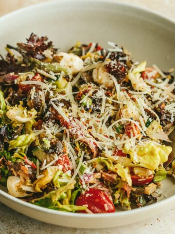 Pizza salad in a beige bowl.